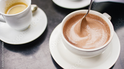 Hot chocolate being stirred with a spoon
