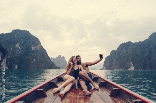 Couple taking selfie on a longtail boat photo