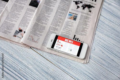 Phone with news on screen a...