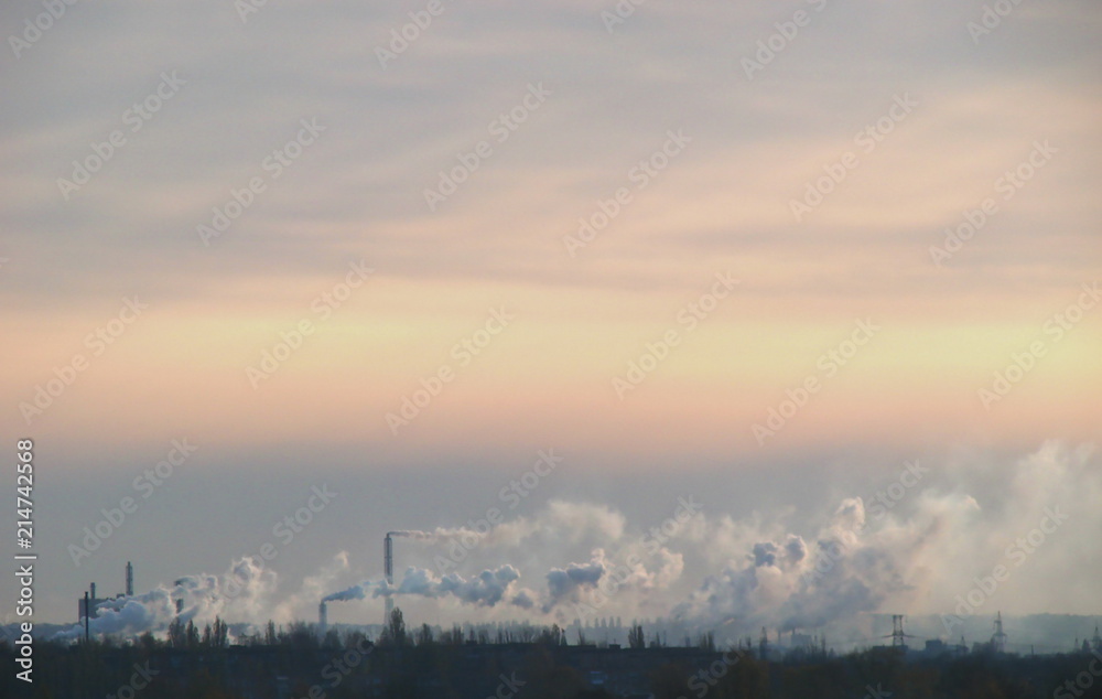 Sunset landscape with industrial smoke
