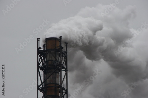 smoking industrial pipe on gray sky