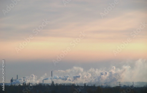 Sunset landscape with industrial smoke © fotosergio