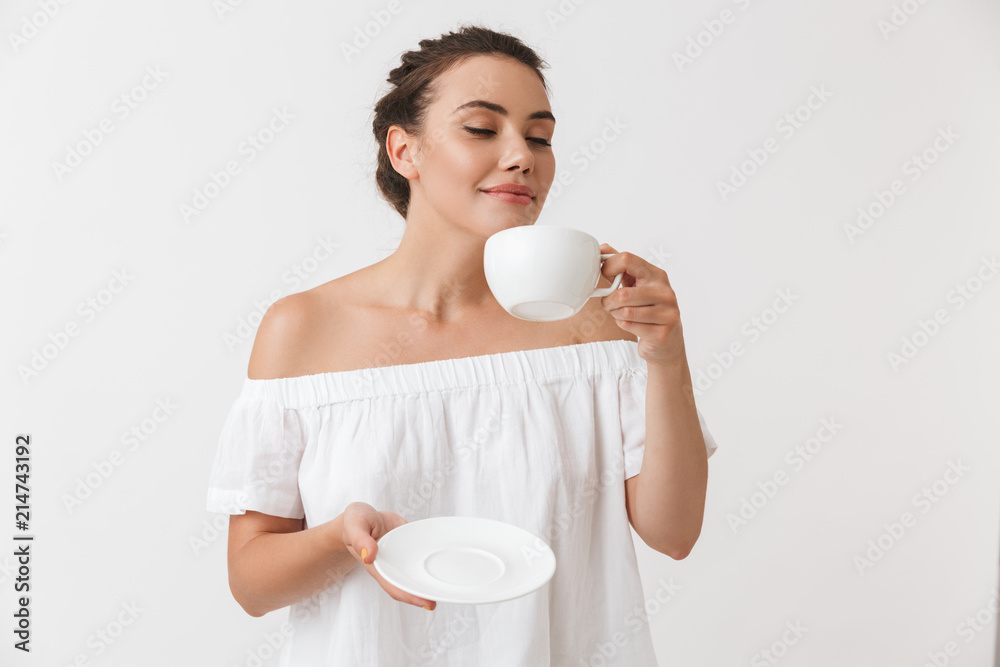 Portrait of a delighted young casual brunette woman