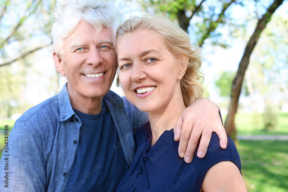 Mature couple resting in park on spring day Mature couple resting in park on spring day