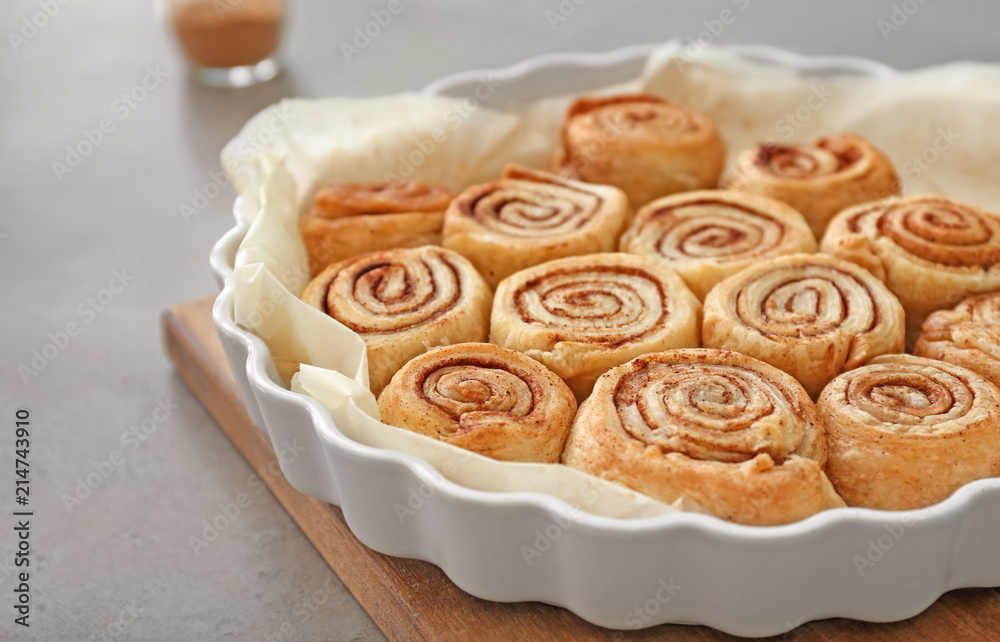 Baking dish with tasty cinnamon buns on table Baking dish with tasty cinnamon buns on table