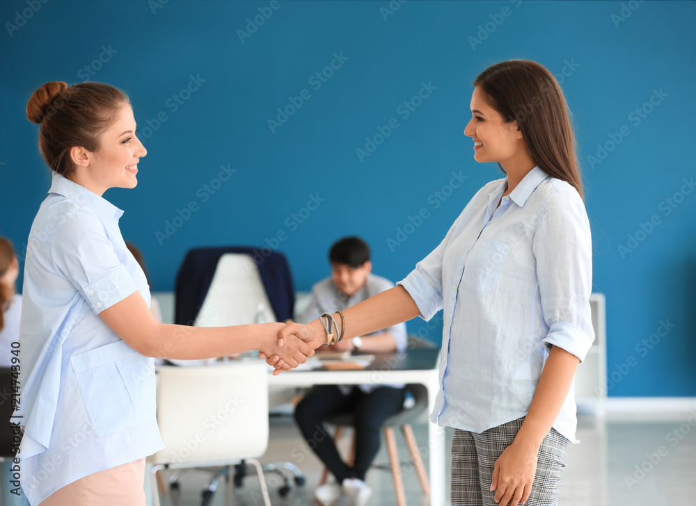People shaking hands during business meeting in office People shaking hands during business meeting in office