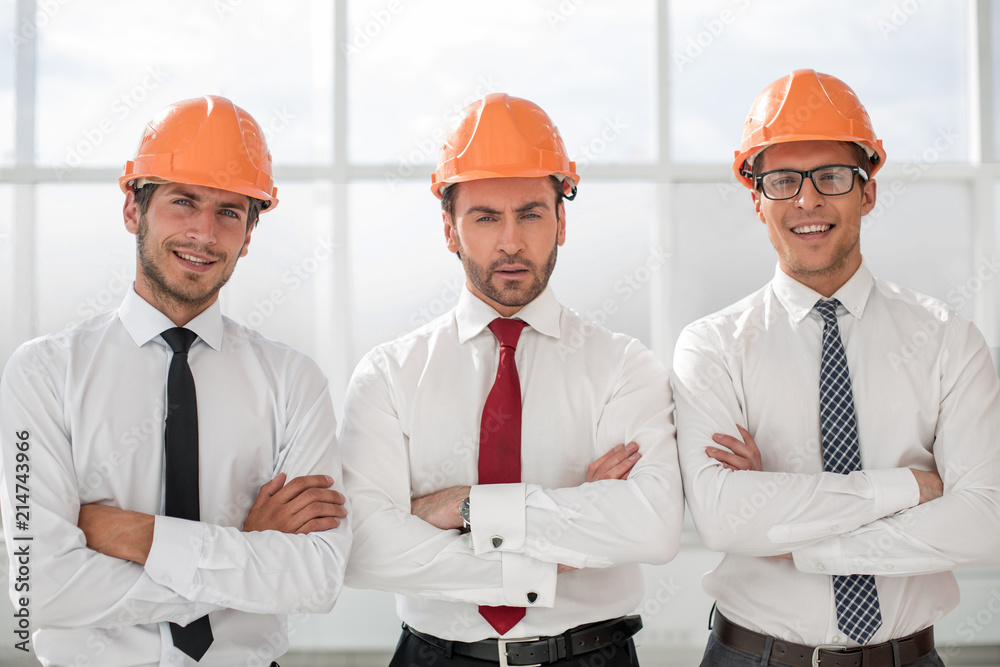 close up.three confident business men in protective helmets close up.three confident business men in protective helmets