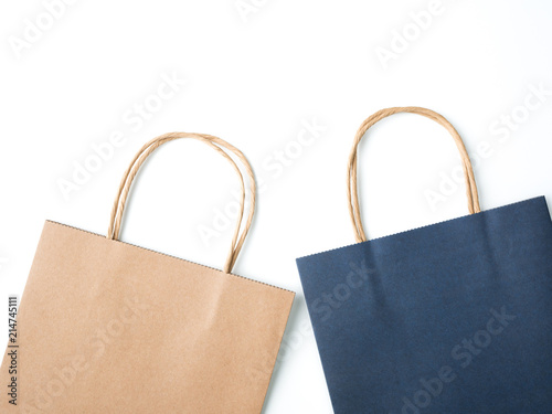 Top view brown and blue paper shopping bag on white background, Mock-up of blank brown and blue paper shopping bag and copy space. Flat lay.