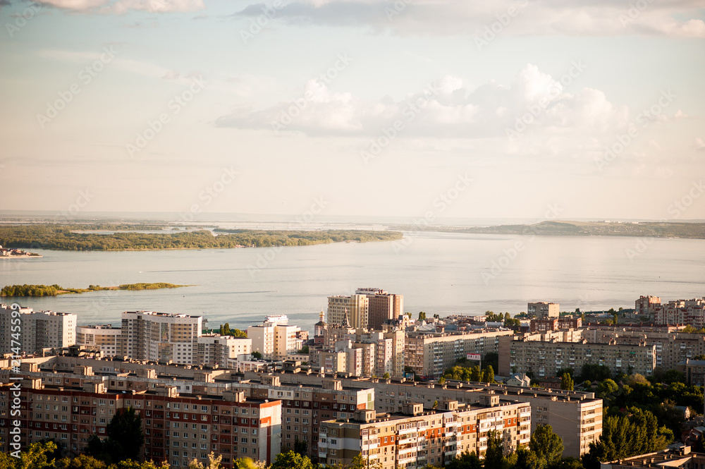 Naklejka premium Saratov, Russia, view of the houses, the Volga River, the bridge to Engels. The landscape of the city from a height.