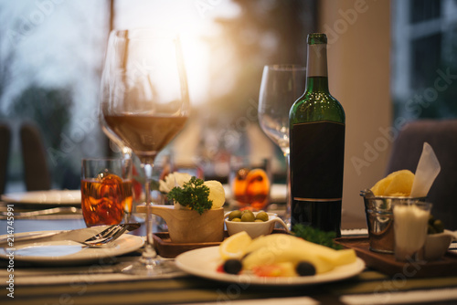 Red wine glass with Cheese plates served with tomato and olive