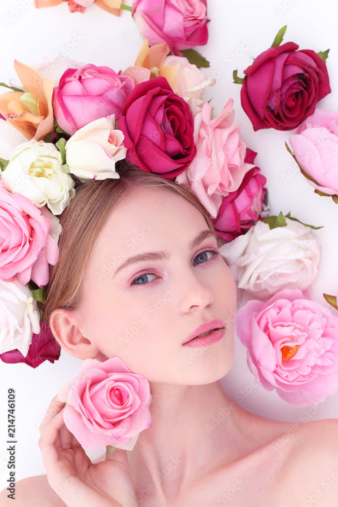 Portrait of a beautiful blonde woman with flowers in her hair.