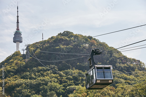 Cable car from Seoul Tower with mountain background in the sunny day