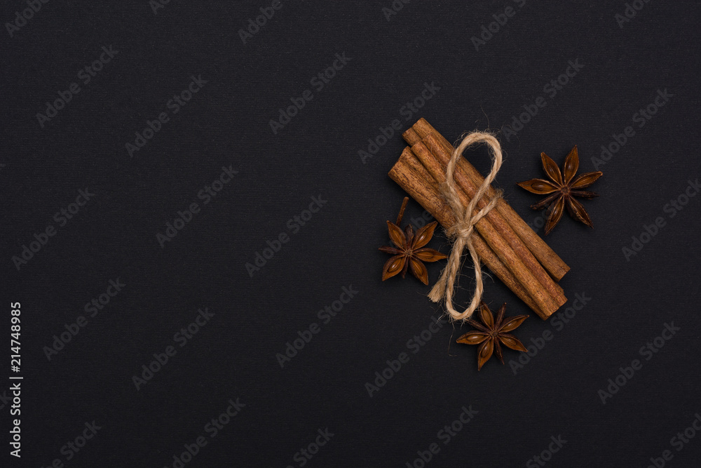 cinnamon sticks and cardamom on a black background top view with copy space for text cinnamon sticks and cardamom on a black background top view with copy space for text