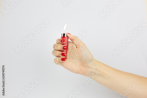 red lighter with fire in woman's hand isolated on white background