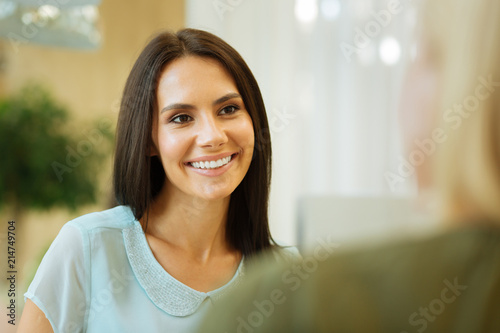 Free Download Happy smile. Portrait of a cheerful brunette woman while looking at her interlocutor - GFXLoad