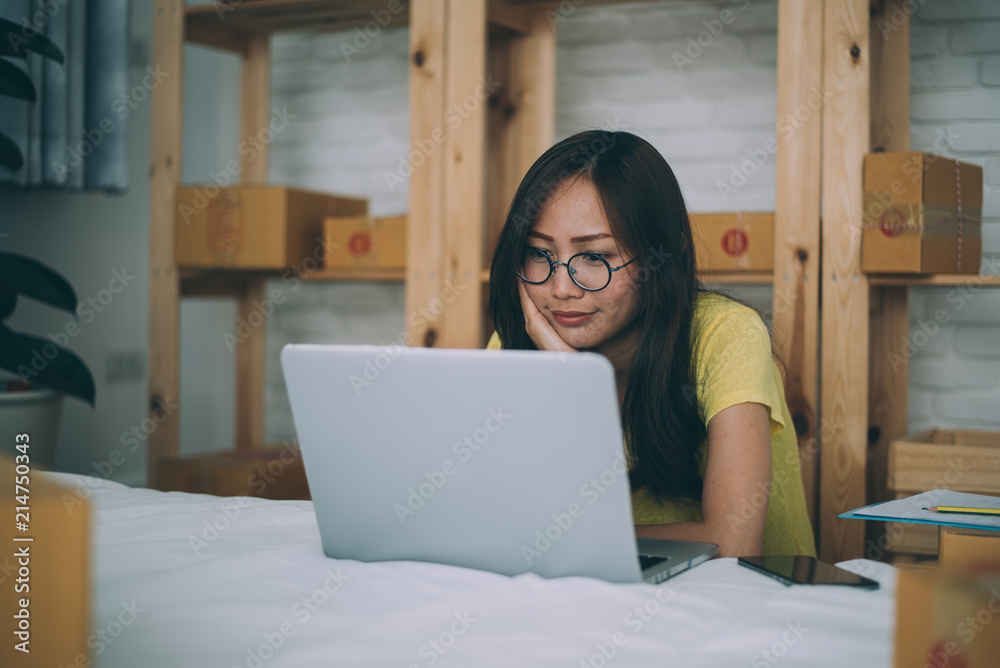 Naklejka premium Young Asian Woman Working at home, Young business start up online seller owner, Delivery Project, Woman with Online Business or SME Concept.