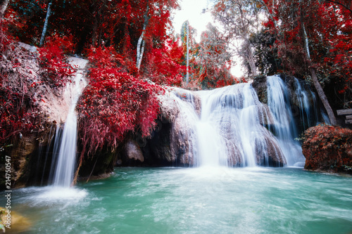 Beautiful waterfalls with red color leafs trees. Autumn scenes.