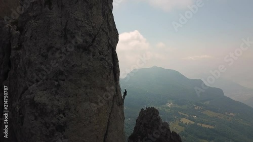 drone view of two person climbing a rock