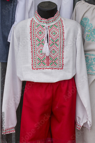 Display of embroidered Ukrainian slavic men traditional shirts embroidery clothing in outdoor flea market in Lviv, Ukraine. Ethnic texture design on the cloth © OlegD