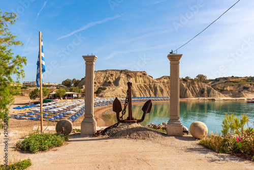 Fototapeta Naklejka Na Ścianę i Meble -  Ancient columns with anchore at harbor in Kolymbia village. Rhodes island. Greece