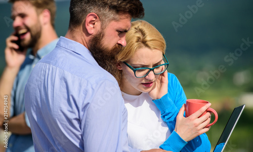 Coffee break concept. Colleagues pay attention screen laptop while man talking phone. Business partners meeting non formal atmosphere. Colleagues with laptop work outdoor sunny day, nature background © be free