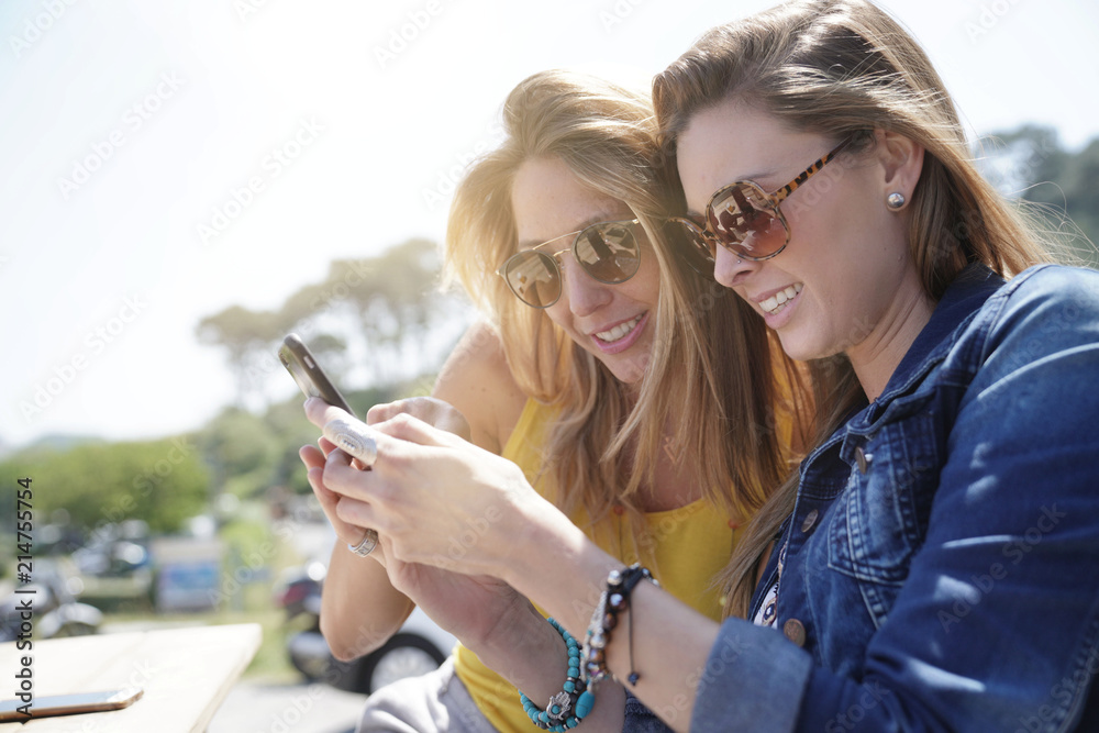 Trendy girls taking selfie pictures with smartphone Trendy girls taking selfie pictures with smartphone