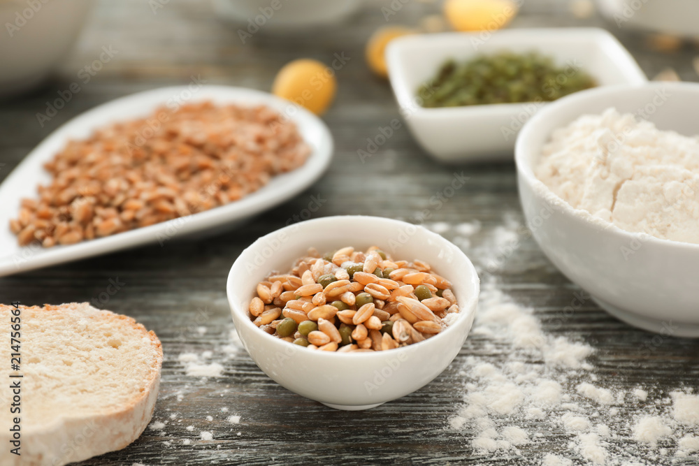 Bowl with wheat grains and beans on wooden table Bowl with wheat grains and beans on wooden table