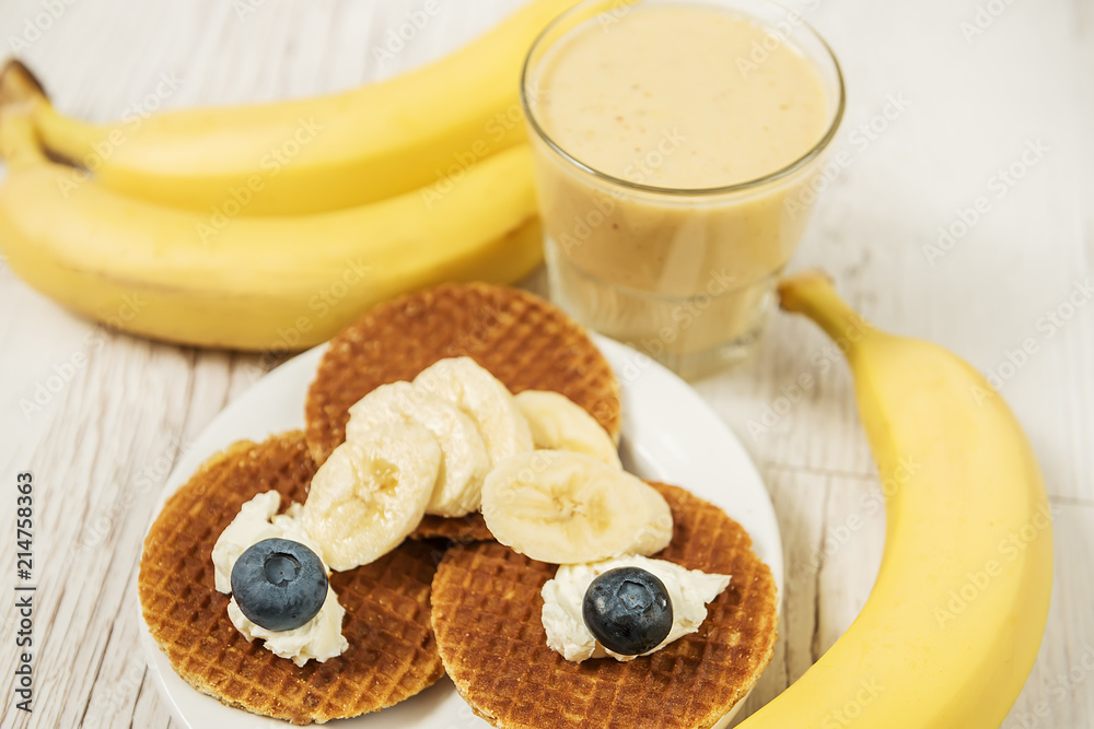 Wafers with blueberries and cheese and banana fresh. Different fruit and delicious breakfast.
