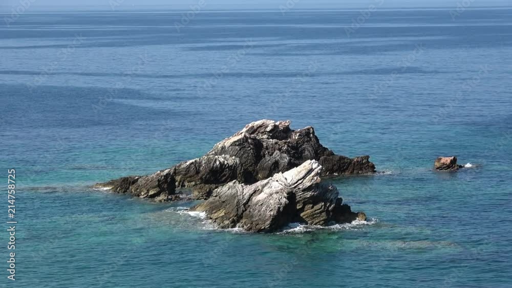 Blue sea water surface, ocean waves pattern background. Waves crashing against rocks Blue sea water surface, ocean waves pattern background. Waves crashing against rocks