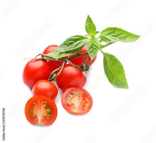 Fresh ripe tomatoes with basil leaves on white background