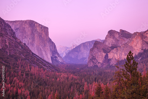 Magenta sunset in Yosemite National Park. El Capitan and Half Dome Tunnel View overlook in a pink sunset, golden hour. Summer american holidays. California, United States.
