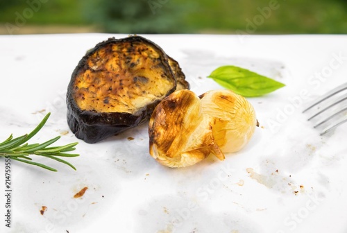 Fotografi Two grilled pieces of vegetable on dirty white background.
