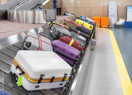 Suitcases on luggage conveyor belt at arrival area of airport © efired