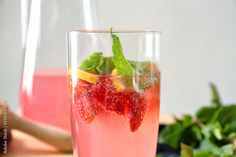 Glass of tasty strawberry lemonade on blurred background, closeup Glass of tasty strawberry lemonade on blurred background, closeup