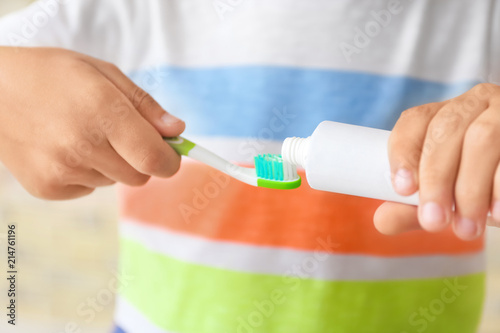 Little boy with toothbrush and paste, closeup