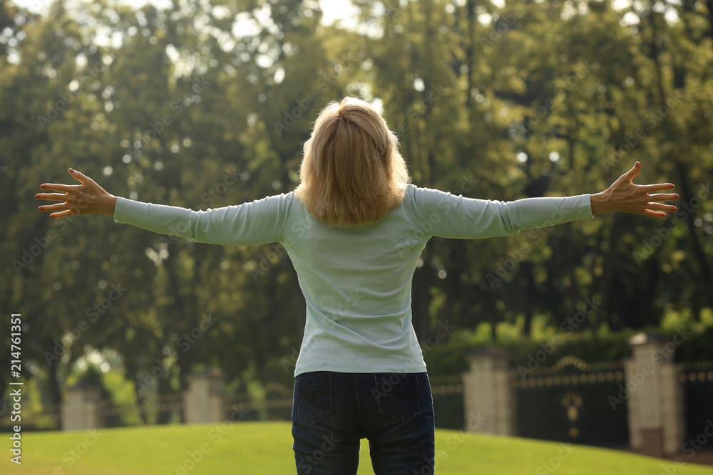 Beautiful mature woman outdoors on summer day