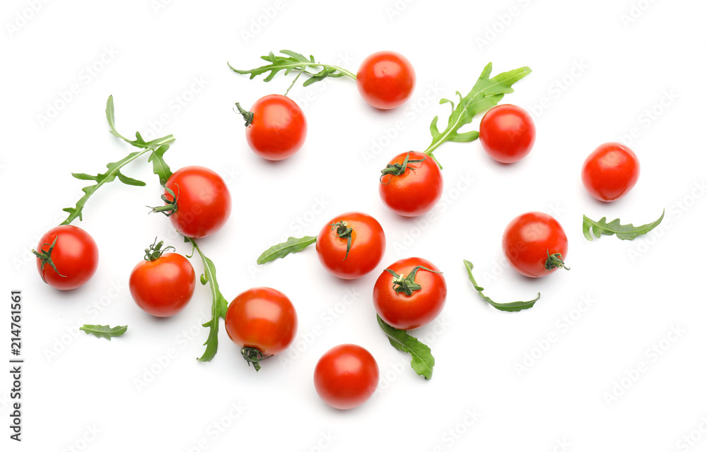 Fresh cherry tomatoes with arugula on white background Fresh cherry tomatoes with arugula on white background