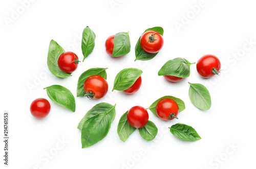 Fresh cherry tomatoes with basil on white background