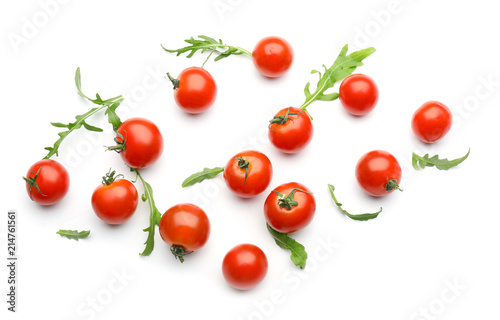 Fresh cherry tomatoes with arugula on white background