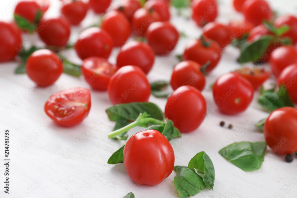 Fresh cherry tomatoes with basil on wooden background Fresh cherry tomatoes with basil on wooden background