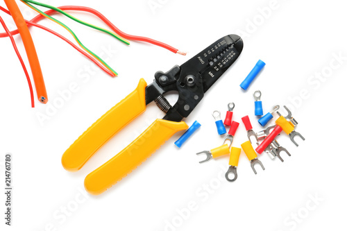 Wire stripper with cables and terminal ends on white background photo