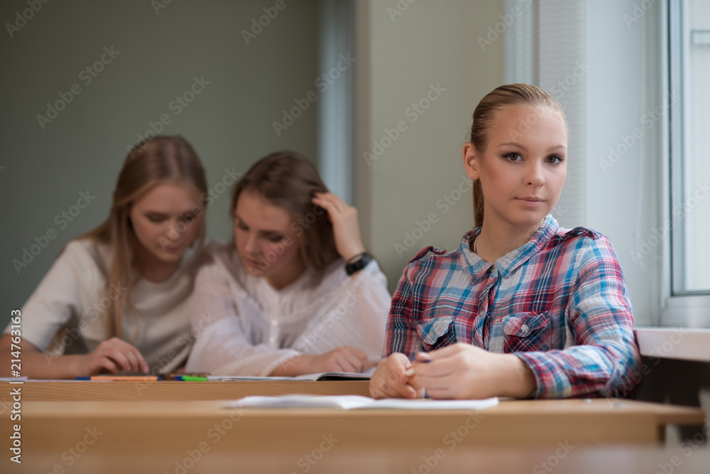 student girls are sitting at a Desk student girls are sitting at a Desk