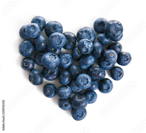 Heart made of ripe blueberries on white background
