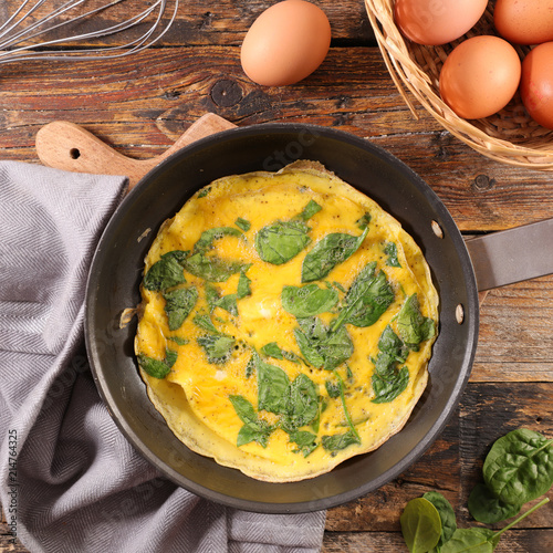 spinach omelet on wood background