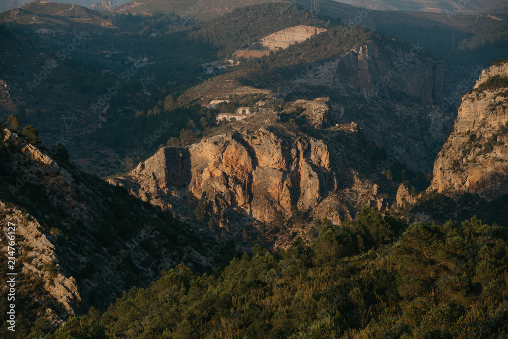 Rocky mountain between other mountains in Spain on the sunset