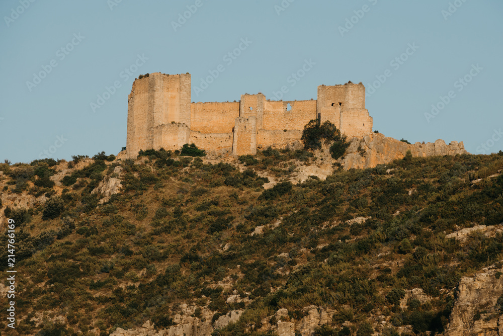 An ancient castle on the top of the hill on the sunset in Spain. El Castillo de Chirel. 