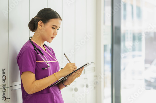 female doctor hold clipboard pad and fill medical history list at workplace. 