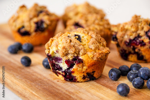 Valokuvatapetti freshly baked blueberry muffins with an oat crumble topping on a natural wooden