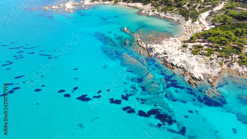 Aerial view of beautiful sandy and rocky Orange beach, people sunbathing and swimming. Amazing and famous Portokali beach on Sithonia near Sarti, Greece