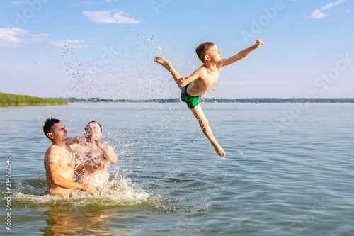 Photography Two young adults and one kid boy having fun in river or lake